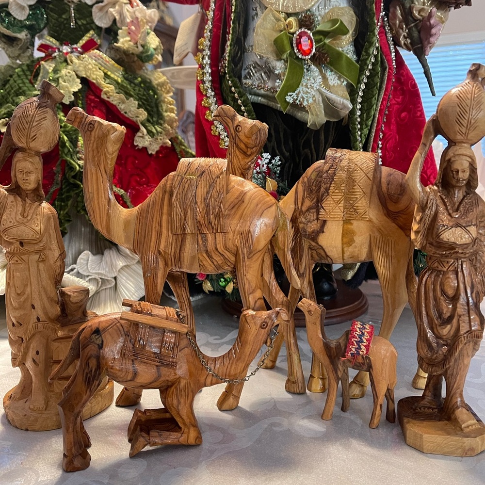 Bundle of hand craft olivewood camels, and ladies figure